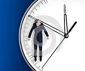 Businessman hangs on an arrow of clock