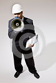 Businessman in hard-hat with walkie-talkie