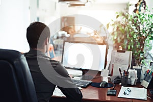 Businessman hard at work on a computer in an office
