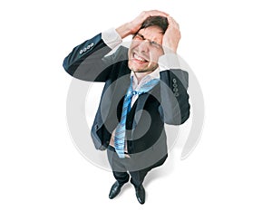Businessman has headache and is holding his head. View from top.