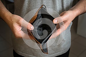 Businessman has no money. Unemployed and bankrupt man looks into his empty wallet. Stress crisis, unemployed businessmen waiting