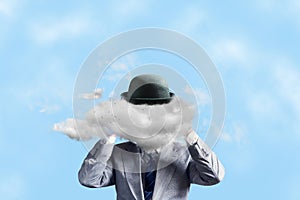 Businessman in a hat, with a cloud instead of a head, with arms raised. The concept of tough decision making, creative