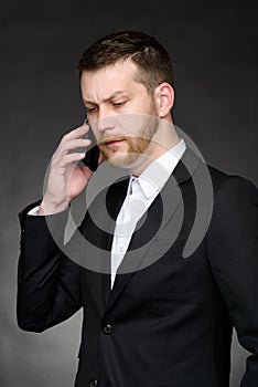 Businessman having conversation on smartphone