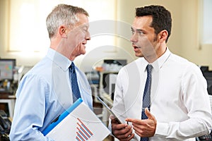 Businessman Having Discussion With Senior Mentor In Office