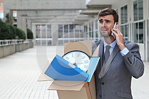 Businessman having a dramatic moment on the phone after being fired