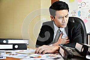 Businessman having heart attack.