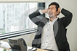 Businessman having office syndrome with symptom of getting stress and headache