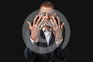 Businessman having panic attack on dark background