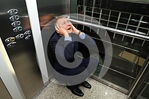 Businessman having panic attack in elevator