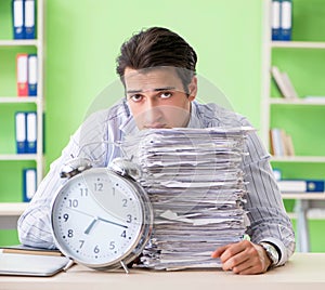 Businessman having problems with paperwork and workload