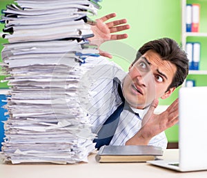 Businessman having problems with paperwork and workload