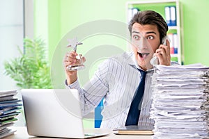 The businessman having problems with paperwork and workload