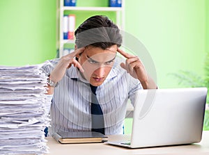 Businessman having problems with paperwork and workload