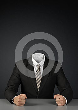 Businessman without head on dark with copy-space