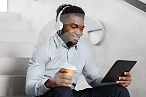 Businessman with headphones and tablet pc