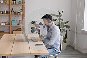 Businessman in headphones use laptop explain infographic lead virtual briefing