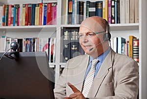Businessman with headphones and webcam