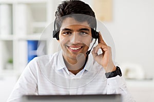 Businessman with headset and computer at office