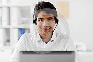 Businessman with headset and computer at office