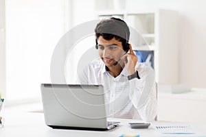 Businessman with headset and laptop at office