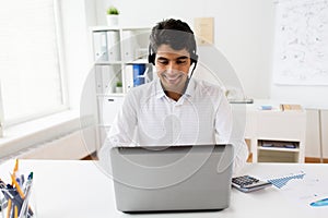 Businessman with headset and laptop at office