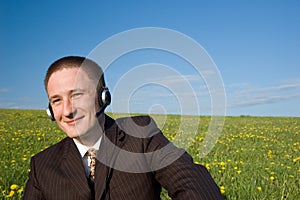 Businessman with headset and laptop outdoor