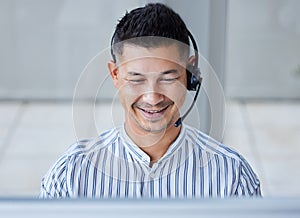 Businessman, headset and telemarketing at call centre for customer service, smile or technical support. Male person