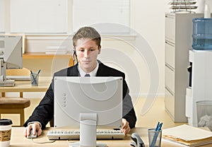 Businessman in headset working at computer