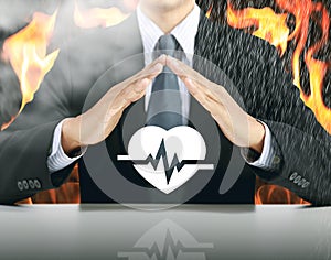 Businessman and heartbeat with fire background