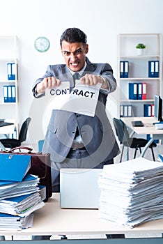 Businessman with heavy paperwork workload