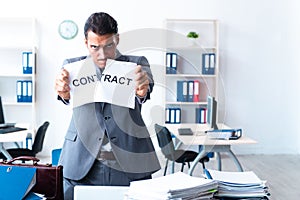 Businessman with heavy paperwork workload