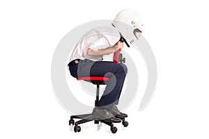 Businessman with helmet racing in a chair