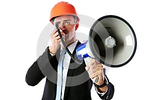 Businessman in helmet shouting with megaphone