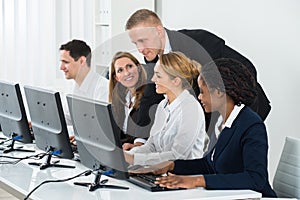 Businessman Helping His Colleagues In The Office