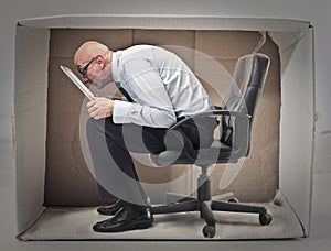 Businessman hiding in a box