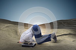 The businessman hiding his head in sand escaping from problems