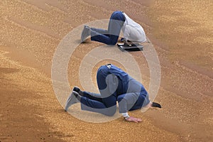 The businessman hiding his head in sand escaping from problems