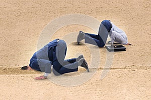 The businessman hiding his head in sand escaping from problems