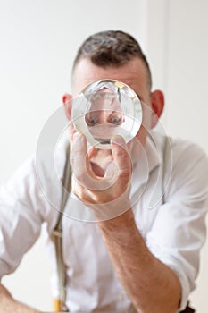 Businessman in his 50s looks at a crystal ball