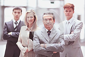 Businessman and his business team on blurred office background