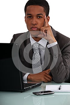 Businessman at his desk thinking