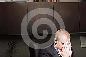 Businessman with his head in his hands photo