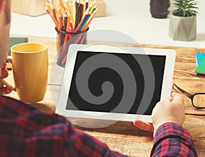 Businessman in his home office holding tablet