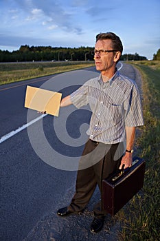 Businessman hitchhiking to work