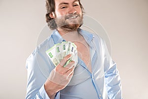 Businessman hold 100 euro cash money banknotes isolated on a gray background,focus on money