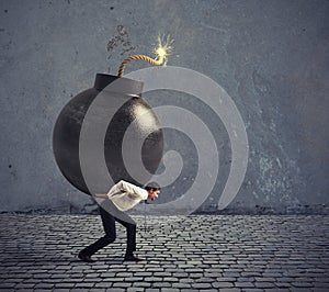 Businessman hold a bomb. Concept of difficult career and failure