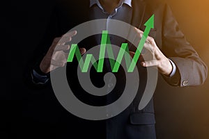 Businessman hold drawing on screen growing graph, arrow of positive growth icon.pointing at creative business chart with upward