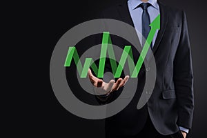 Businessman hold drawing on screen growing graph  arrow of positive growth icon.pointing at creative business chart with upward