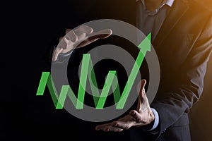 Businessman hold drawing on screen growing graph, arrow of positive growth icon.pointing at creative business chart with upward