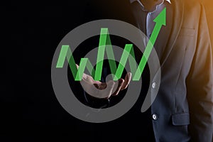 Businessman hold drawing on screen growing graph, arrow of positive growth icon.pointing at creative business chart with upward